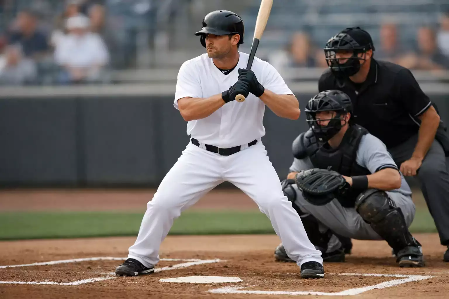 Baseball batter in hitting stance at home plate preparing for a pitch
