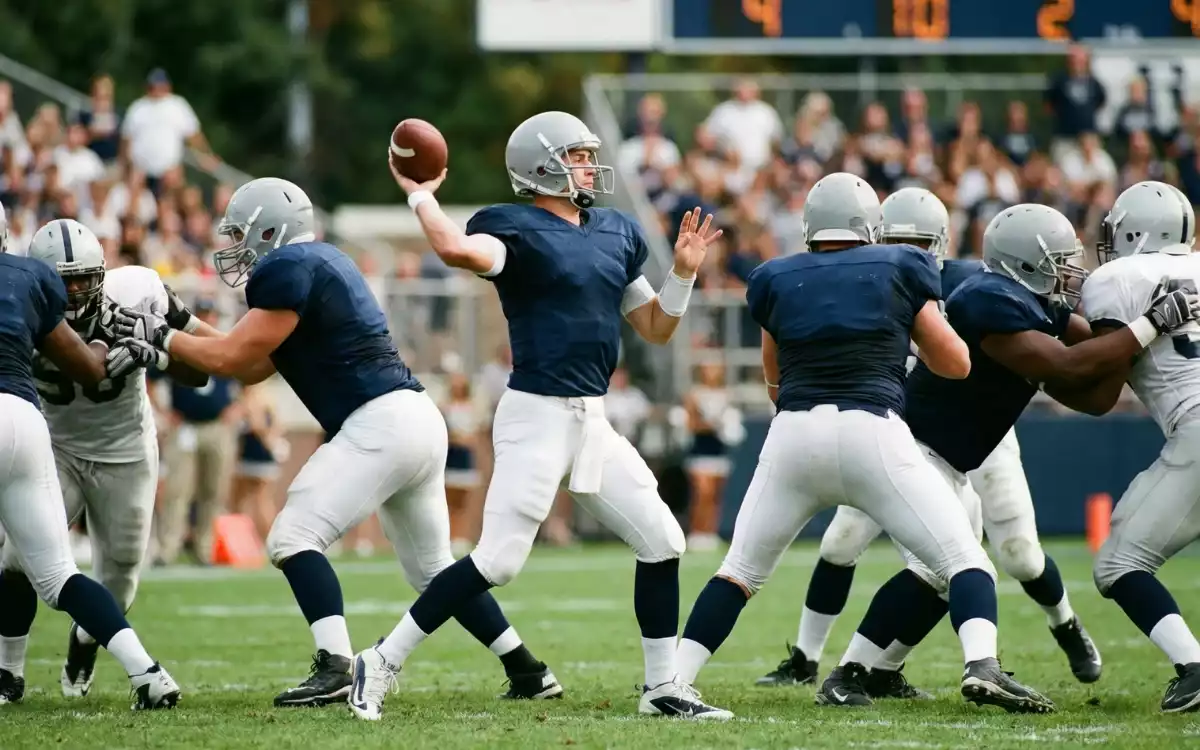 NFL quarterback preparing to throw a pass during a game with offensive line blocking
